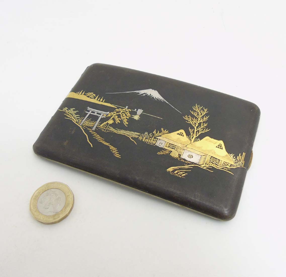 An early 20thC Japanese Amita hip formed cigarette case with damascene style decoration depicting