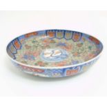 A Large Chinese bowl decorated in Imari style colours on a white ground,