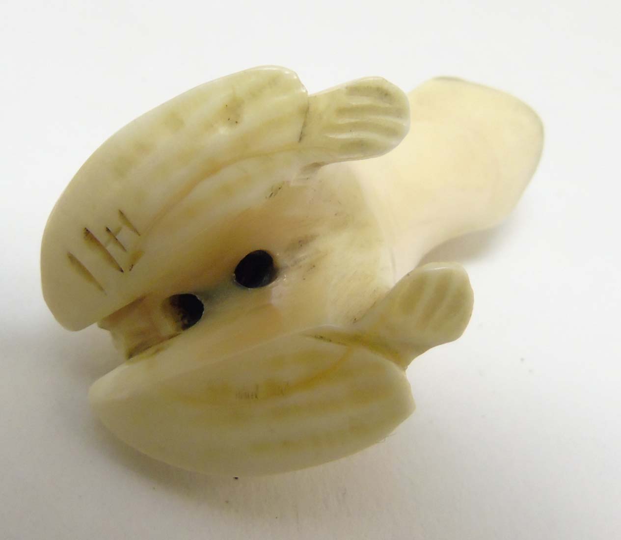 A Japanese Meiji period signed ivory netsuke formed as a frog with black eyes. - Image 8 of 8