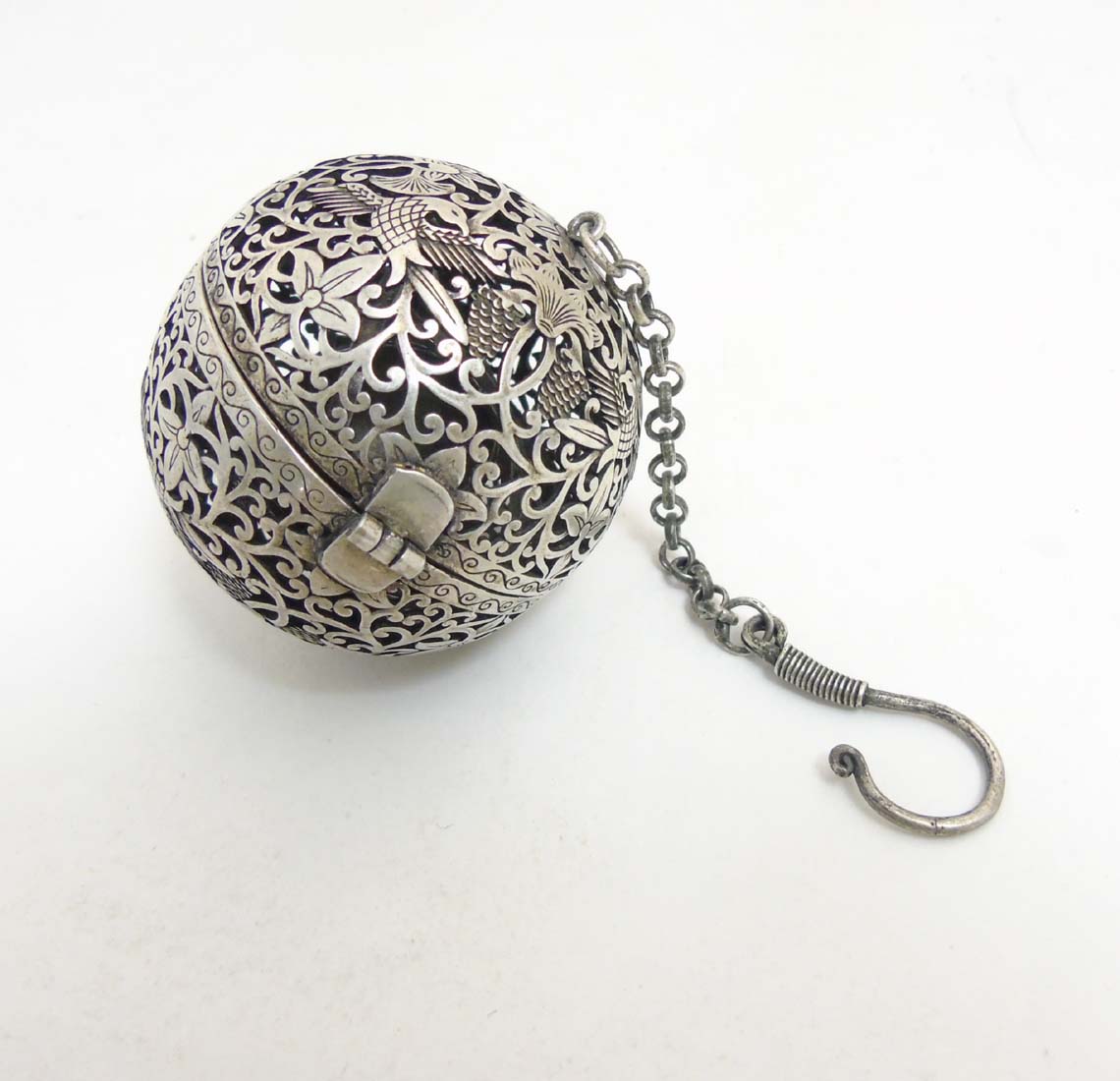 A Chinese white metal Sensor Ball with pierced decoration of birds etc 2 1/4" diameter