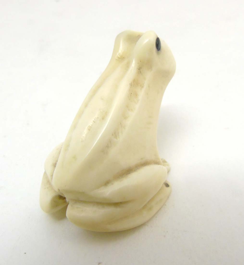 A Japanese Meiji period signed ivory netsuke formed as a frog with black eyes. - Image 5 of 8