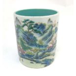 A Chinese famille rose brush pot painted in enamels depicting a continuous landscape scene of