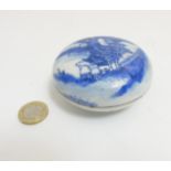 A Chinese circular blue and white lidded pot containing red ink paste,