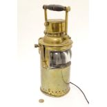 A late 19thC brass hand held maritime light? fisherman's lamp? now converted for electricity,.