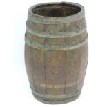 An old oak coopered barrel of oval form with brass banding.