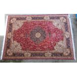 Rug / Carpet : Keshan machine made carpet with red ground border and central panel with floral