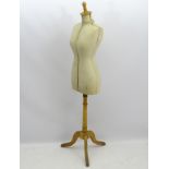 An early 20thC French dress maker's mannequin, fully adjustable and standing on a tripod base.