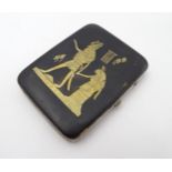 An mid 20thC cigarette case with Egyptian damascene style decoration depicting Horus and another.