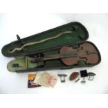 Musical Instruments : A cased Victorian violin and bow, together with accessories and strings etc.