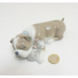 A Lladro 'Unlikely Friends' figurine of a bulldog and kitten sleeping, makers mark to base,