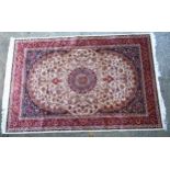 Rug / Carpet : Keshan machine made rug with beige ground, red border, in creams, red and navy.