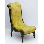 An ebonised Aesthetic Movement nursing chair with contrasting burr walnut veneers and ivorine inlay,