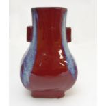 A Chinese Fang Hu flambe vase with Sang de Boeuf glaze with blue streaks to edges,