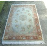 Carpet / Rug : A large rug , purchased from Harrods , having fawn ,