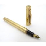 A 9ct gold 'Swan' fountain pen by Mabie Todd & Co, having a 14ct gold nib,
