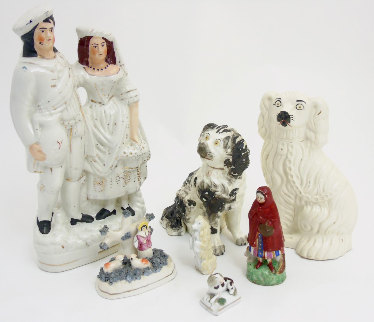 A quantity of Staffordshire items comprising a Scottish couple, a figure and sheep group, - Image 3 of 7