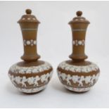 A pair of late 19thC Doulton Lambeth Silicon Ware lidded vases with a squat globular body and tall