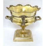 A brass and silver plated champagne cooler of pedestal urn form with twin handles.