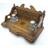 A Victorian carved oak Inkwell Standish with two squared inkwells etc.