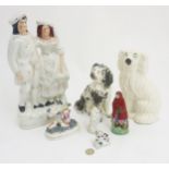 A quantity of Staffordshire items comprising a Scottish couple, a figure and sheep group,