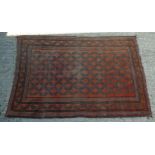 Rug / Carpet : Rust coloured background with a blue, brown, black and cream geometric design.
