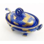 A Flow Blue Ironstone Staffordshire lidded tureen with serving spoon decorated with foliate designs