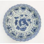 A Chinese blue and white 'Grape' dish / charger: A large Chinese charger with barbed rim,