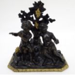 A 19thC bronze patinated gilt figure group with ormulu base, depicting a young satyr and another.