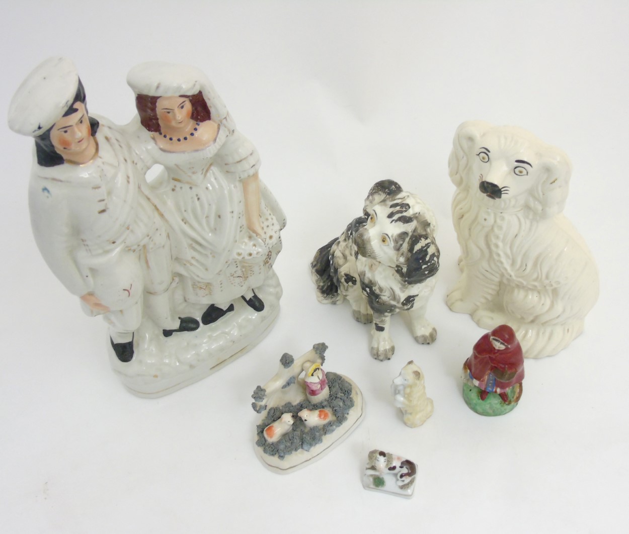 A quantity of Staffordshire items comprising a Scottish couple, a figure and sheep group, - Image 7 of 7