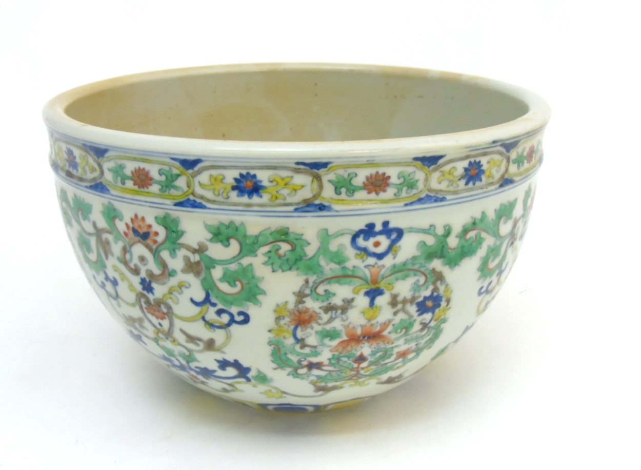 A Chinese Doucai jardiniere, with lotus scroll decoration across body,