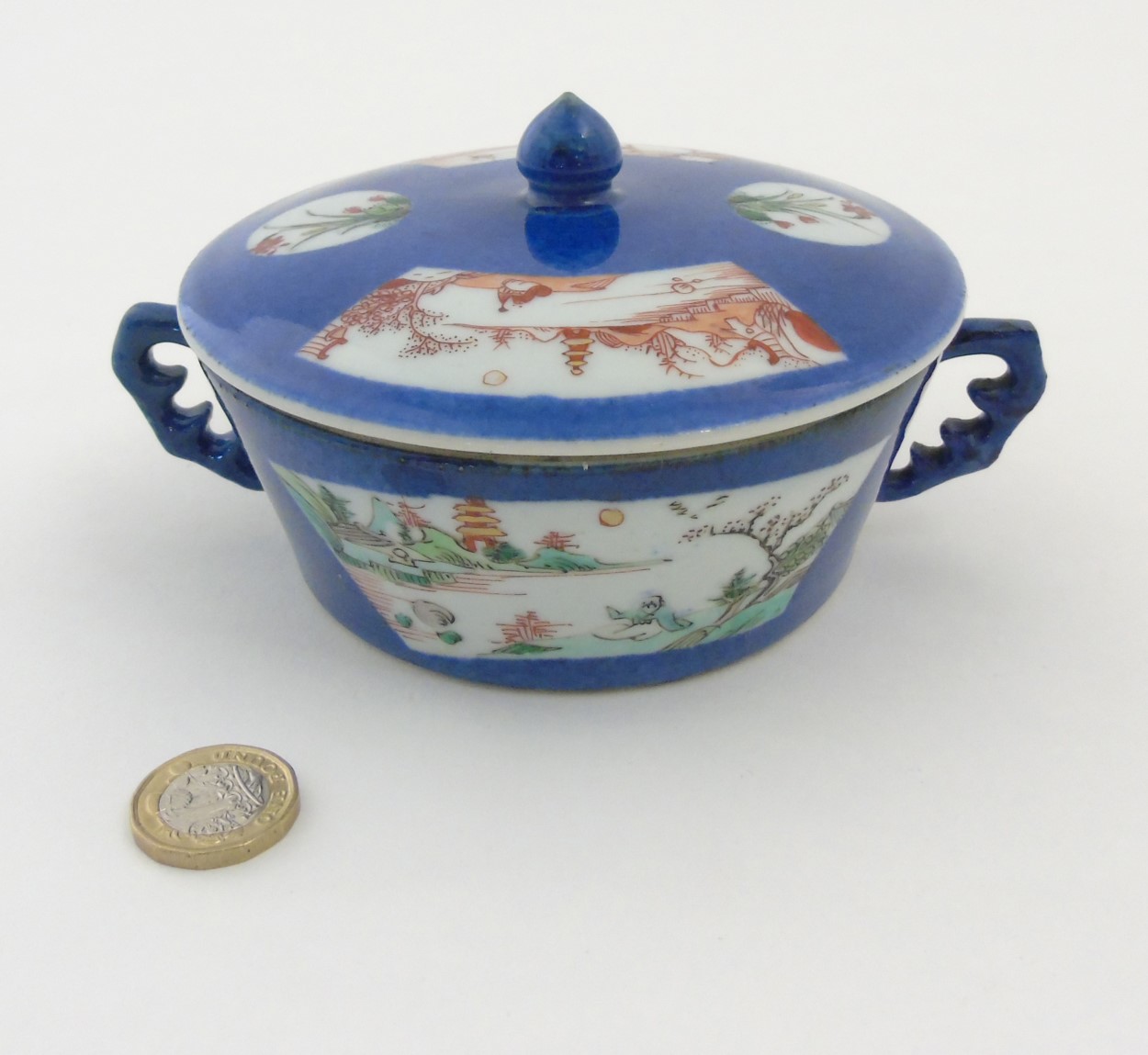 A Chinese pot and lid with handles,