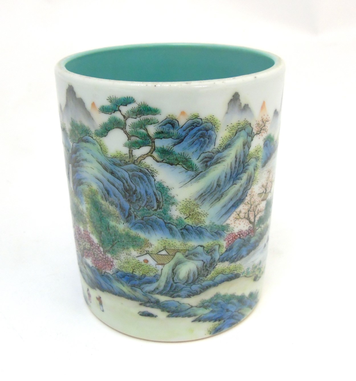 A Chinese famille rose brush pot painted in enamels depicting a continuous landscape scene of