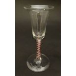 A pedestal drinking glass with coloured air twist decoration to stem,