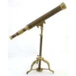 A 19thC brass desk telescope one adjustable 3-footed stand,