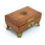 A Regency gold tooled leather covered small sewing box with gilded legs,