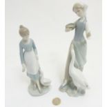 A Lladro figurine of a girl feeding a goose, makers mark to base, 9 1/2" high,
