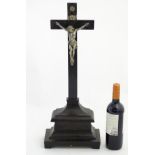 An ebonised wooden crucifix on stand with silver plated figure of Christ etc.