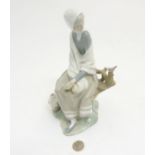 A Lladro 'New Shepherdess' figurine of a girl sat watching a bird, makers mark to base,