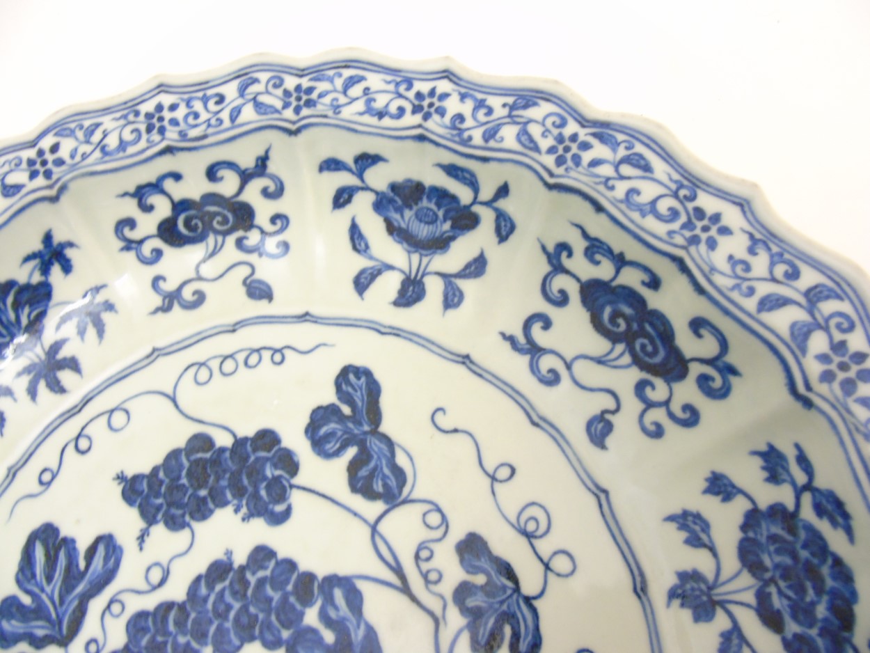 A Chinese blue and white 'Grape' dish / charger: A large Chinese charger with barbed rim, - Image 4 of 9