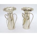 Arts and Crafts : a pair of silver plated flared wavy rim vases each with three loop handles ,