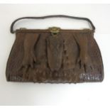 An early 20thC vintage ladies large crocodile skin handbag with head and feet decoration,