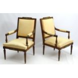 A pair of 19thC Louis XVI style fauteuil chairs with shaped top rail and applied gilt foliate mount,