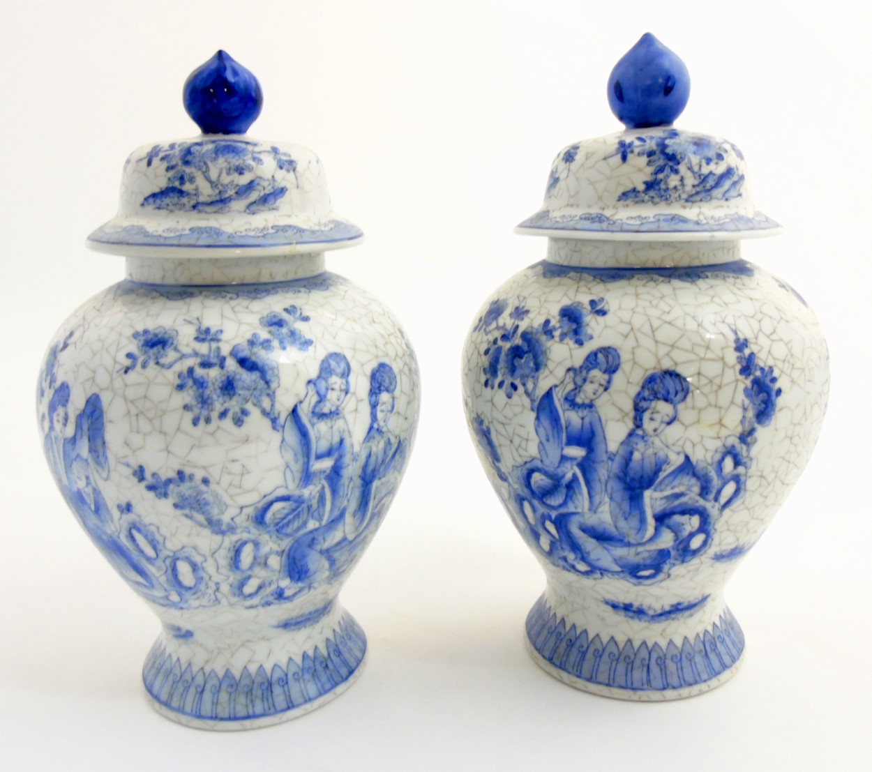 A pair of Maitland Smith blue and white oriental lidded vases with craquelure style decoration,