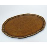 A walnut oval tray with pie crust decoration CONDITION: Please Note - we do not