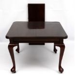 An early 20thC Queen Anne style stained pine dining table with single leaf.