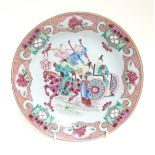 A Chinese Famille Rose enamelled plate depicting a warrior on horseback and other oriental figures,