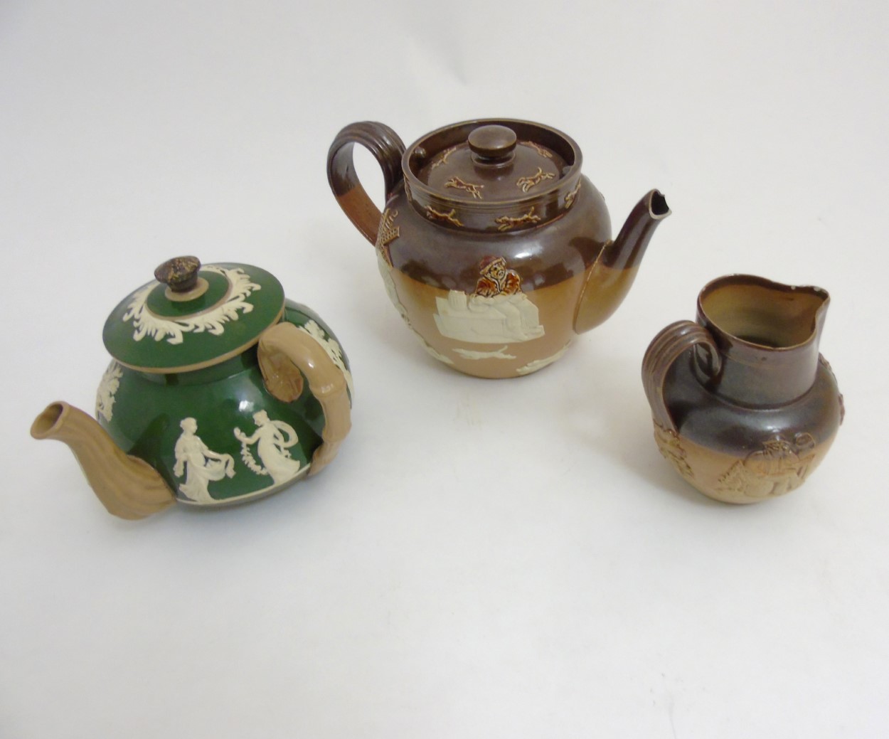 Three pieces of stoneware ceramics comprising a Royal Doulton salt glazed hunting teapot, - Image 6 of 9