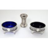 A pair of silver plate table salts with blue glass liners together with a Peugeot Freres Pepper
