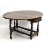 A 17thC and later oak gateleg table with single end drawer and opening to form an oval,