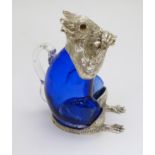 Glass : a 21 st C blue glass and silver plate claret jug in the form of a squirrel eating a nut ,